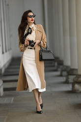 a lady in a white shirt, a white skirt and a brown trench coat